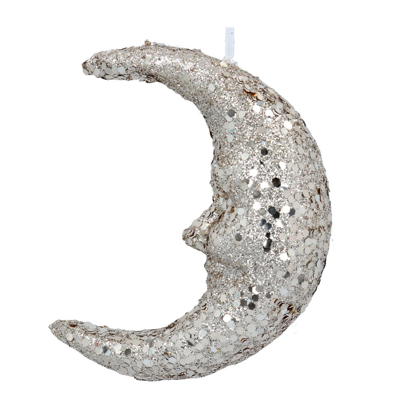 Silver glittery moon-shaped candle on a white background