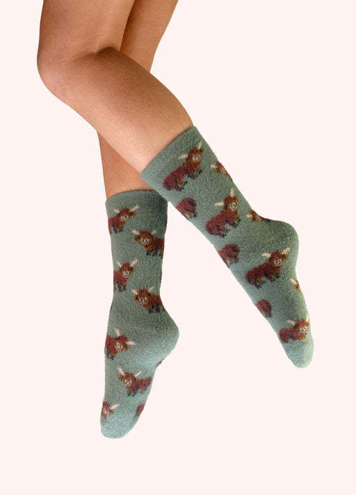 Highland Cow Fuzzy Socks - Green by Powder worn on the leg